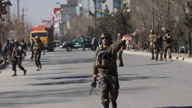 Security personnel arrive outside the site of the suicide attack.