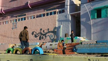Young boys play outside the brighly-coloured buildings in Gaza's al-Shati (Beach) Camp.