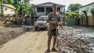 Russell Keys stands at the front of his home on Brisbane Terrace, Goodna,
which has been devastated by flood waters of the Bremer River.