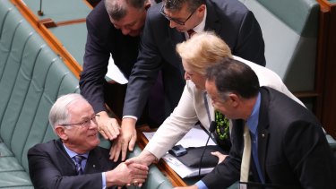 Then trade minister Andrew Robb is congratulated after he concluded the second reading debate on the China - Australia Free Trade Agreement in 2015.