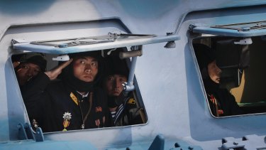 North Korean soldiers look out of a military vehicle as they are paraded on the Kim Il-sung Square during a military parade earlier this month in Pyongyang.