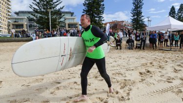 Prime Minister Tony Abbott heads down to the water for his heat at Queenscliff 