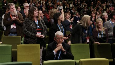 Union figure and same-sex marriage opponent Joe de Bruyn remains seated while Senator Wong is given a standing ovation.
