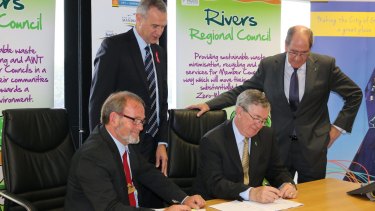 Local Government Minister Tony Simpson and Rivers Regional Council chief executive Alex Sheridan witness Gosnells Mayor Dave Griffiths and RRC chairman Ron Hoffman sign the contract what will end eight councils' dependence on landfill. 