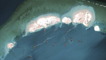 A satellite image shows dredgers working at the northernmost reclamation site of Mischief Reef, part of the Spratly Islands, in the South China Sea, last year.