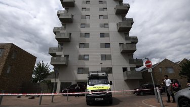 A police van waits outside a block of flats which has been raided by police in connection with the London attack.
