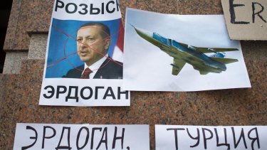 Russian anger: posters showing a portrait of Turkish President Recep Tayyip Erdogan and reading "Wanted Erdogan","Erdogan", and "Turkey", left after a protest at the Turkish embassy in Moscow.