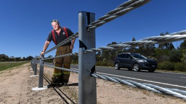 Andy Chapman, Elphinstone CFA captain, inspects wire rope barriers. 