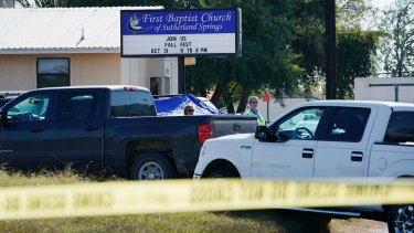 Law enforcement officers work in front of the First Baptist Church of Sutherland Springs after a fatal shooting on Sunday.