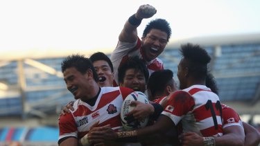 Magic moment: Japan celebrates their second try against South Africa.