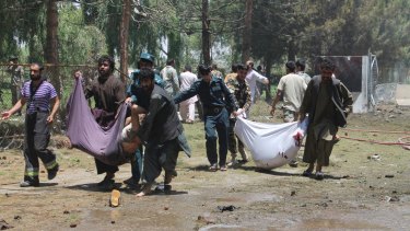The bomber struck outside a bank, targeting Afghan troops and government employees waiting to collect their salaries.