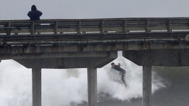 A California surfer catches waves during a winter storm.