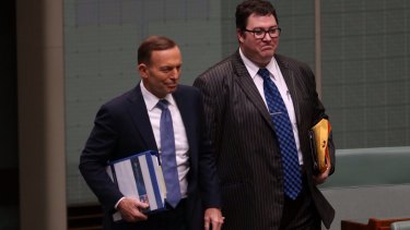 Then prime minister Tony Abbott arrives for question time with George Christensen in 2014.