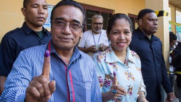 East Timorese President Francisco "Lu-Olo Guterres" and his wife show their fingers after voting in Dili.