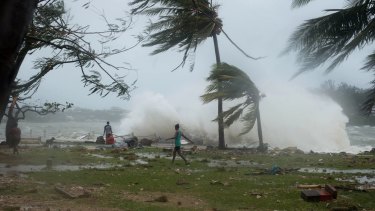 Waves and scattered debris along the coast, caused by Cyclone Pam, in the Vanuatu capital of Port Vila. 