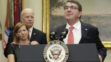 Grabby: New US Secretary of Defence Ashton Carter delivers his acceptance speech at the White House, while US Vice-President Joe Biden stands behind Stephanie Carter with his hands on her shoulders.