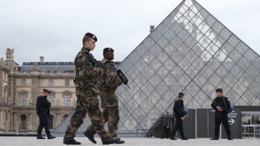 French military and police patrol the
Louvre in Paris