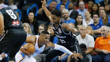 Oklahoma City Thunder guard Russell Westbrook (left) falls as he drives around Melbourne United's Casper Ware.