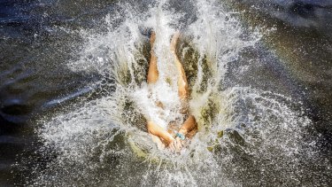 Issac, 17, cools off at Parramatta Lake on Saturday.