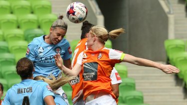 Alanna Kennedy of Melbourne City sends a header towards goal under pressure from the Brisbane defence.