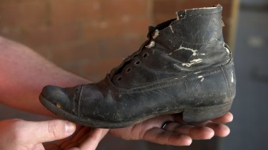 The boot was uncovered behind the fireplace at Children's Court in Surry Hills, more than a century after it was hidden.

