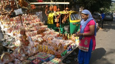 A woman shops for clay Hindu figurines in preparation for Diwali.