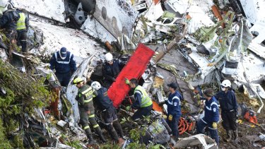 Rescue workers comb through the wreckage of a plane crash south of Medellin in Colombia.