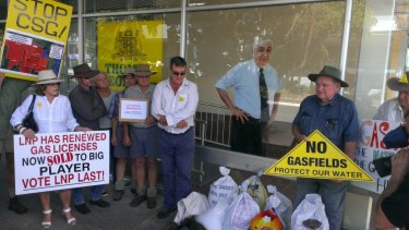 Protesters in Lismore dumping bags of cow manure outside Nationals MP Thomas George's electoral office.