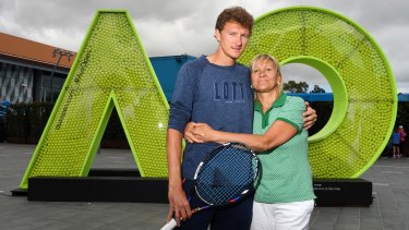 Denis Istomin gives his mother and coach Klaudiya a hug after his Australian Open heroics.