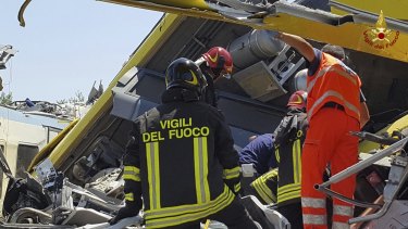 Firefighters inspect the wreckage, where it's believe some people remain trapped.