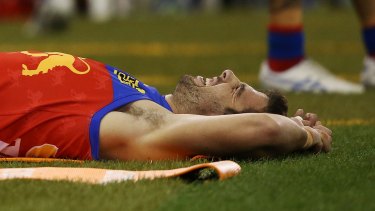 Michael Close on the ground after rupturing his anterior cruciate ligament at Etihad Stadium.