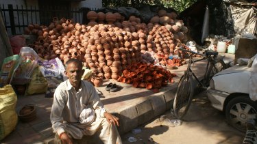 Pottery vendor Ram Kumar waits for customers ahead of the Dwali festival.