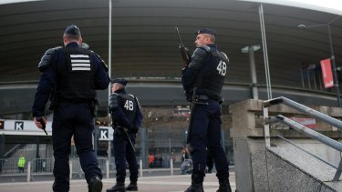 French riot police officers stand guard outside the Stade de France earlier this month. 