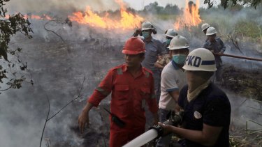Firemen on the frontline in South Sumatra at the weekend. Wildfires caused by illegal land clearing on Indonesia's Sumatra and Borneo islands often spread choking haze to neighbouring countries such as Malaysia and Singapore. 
