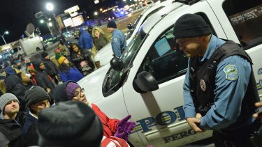 Protesters demonstrate outside the Ferguson Police Department in March. 