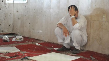 A family member of a slain victim mourns after a suicide bomber struck the Imam Ali mosque in Saudi Arabia in May.