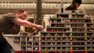Professional Lego builder Ryan McNaught (left) and workers set up for the Lego exhibition at Sydney's Town Hall.