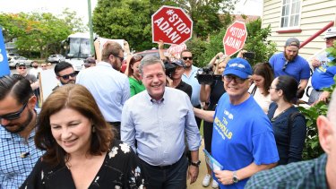 Queensland LNP leader Tim Nicholls was surrounded by anti-Adani protesters as he arrived to vote in his electorate on Saturday.