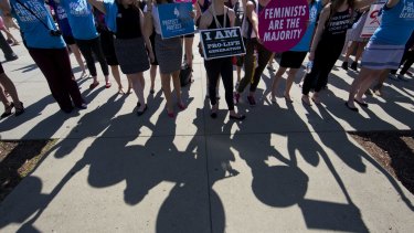 Demonstrators on both sides of the abortion issue stand in front of the Supreme Court in Washington in June.