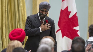 Sikh achievement: Harjit Singh Sajjan reacts after being sworn in as Canada's Defence Minister in Ottawa in November. Seated in the red turban is Navdeep Singh Bains, who was sworn in as Science and Innovation Minister on the same day.
