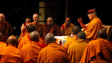  His Holiness The 14th Dalai Lama of Tibe (right) teaching Buddhist monks and practitioners in Brisbane in June.