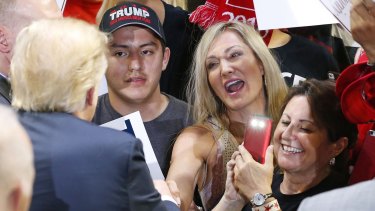 Republican presidential candidate Donald Trump signs autographs for supporters in Phoenix last week.