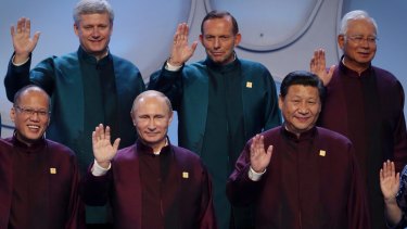 Prime Minister Tony Abbott and other APEC leaders wave.