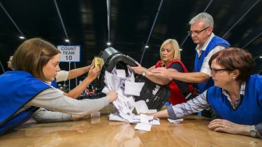 Counters begin to tally ballot papers at the Titanic Exhibition Centre in Belfast, where the Northern Ireland results were calculated.