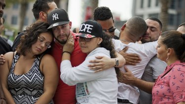 Mourners in Orlando console each other as they grieve the loss of their friends killed in the mass shooting at the Pulse nightclub.