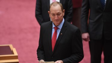 Senator Fraser Anning reads the oath of office as he is sworn in on Monday.