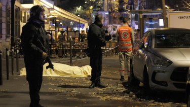 A victim's body lies covered on Boulevard des Filles du Calvaire, close to the Bataclan, early on November 14.