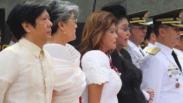 From left, Marcos children Ferdinand "Bongbong" Marcos jnr, Irene Marcos-Araneta, Imee Marcos and their mother Imelda, pay tribute to the flag-draped casket of the late Philippine dictator Ferdinand Marcos at his reburial in November.