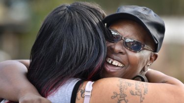Velma Aiken, the paternal grandmother of Kamiyah Mobley, who was kidnapped as an infant 18 years ago, gets a congratulatory hug from a family member after Mobley was found on January 13.