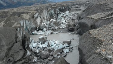 A close-up view of the ice-walled canyon at the terminus of the Kaskawulsh Glacier, with recently collapsed ice blocks, taken in 2016. 